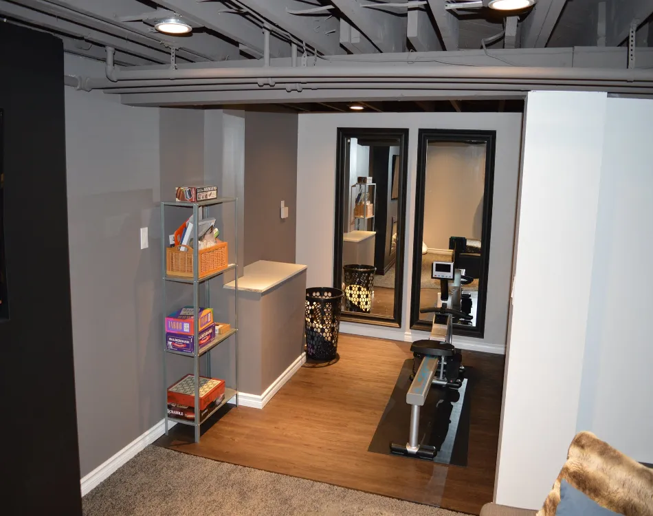 Part of basement with shelf and rowing machine